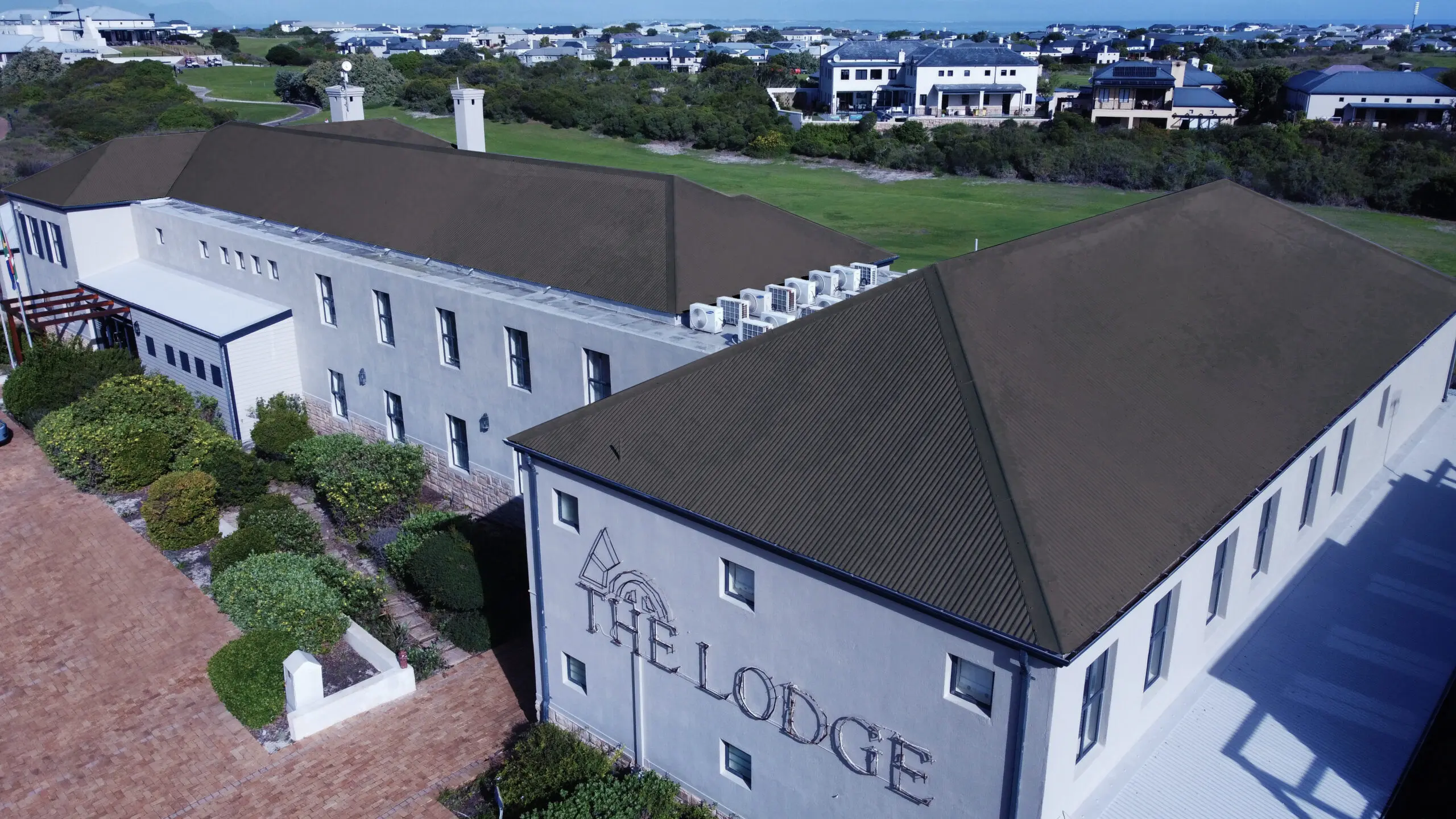 Aerial view of building with rubber roofing installed, showcasing durable waterproof roofs by Rubber Roofs SA.