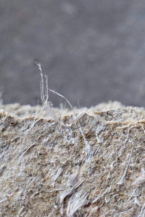 Tattered rubber roofing material showing signs of wear and tear, useful for roof repair insights.
