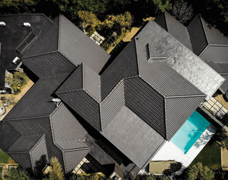 High-quality black rubber roofing on a large residential property with a swimming pool, showcasing durable waterproof roofing solutions by Rubber Roofs SA.