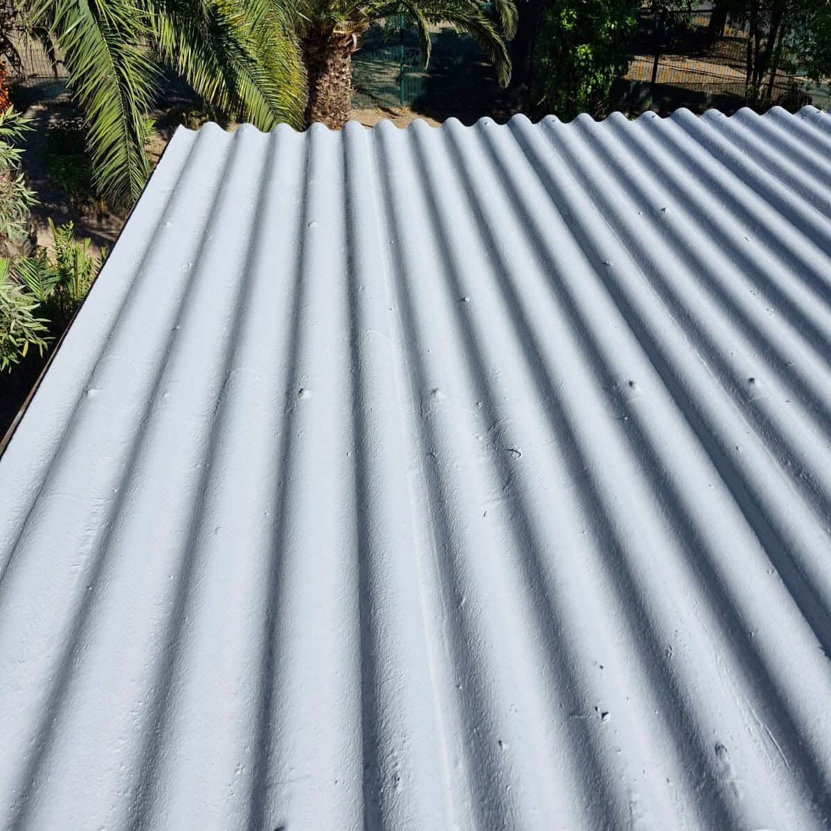 Colorful galvanized metal roof with corrugated design, durable roofing solution from Rubber Roofs SA.