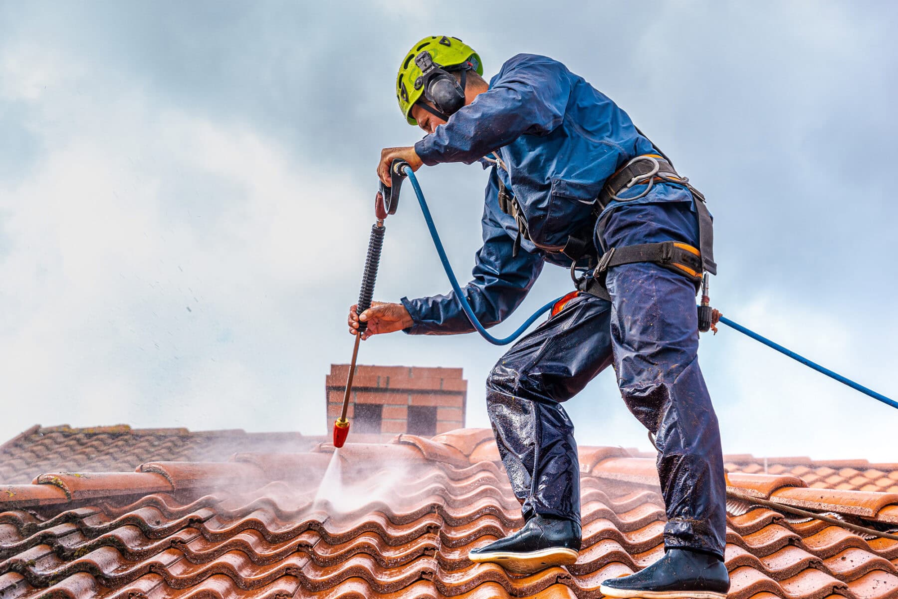 High-pressure roof cleaning service on terracotta tiles, professional roof maintenance, waterproofing, and roof restoration in South Africa.