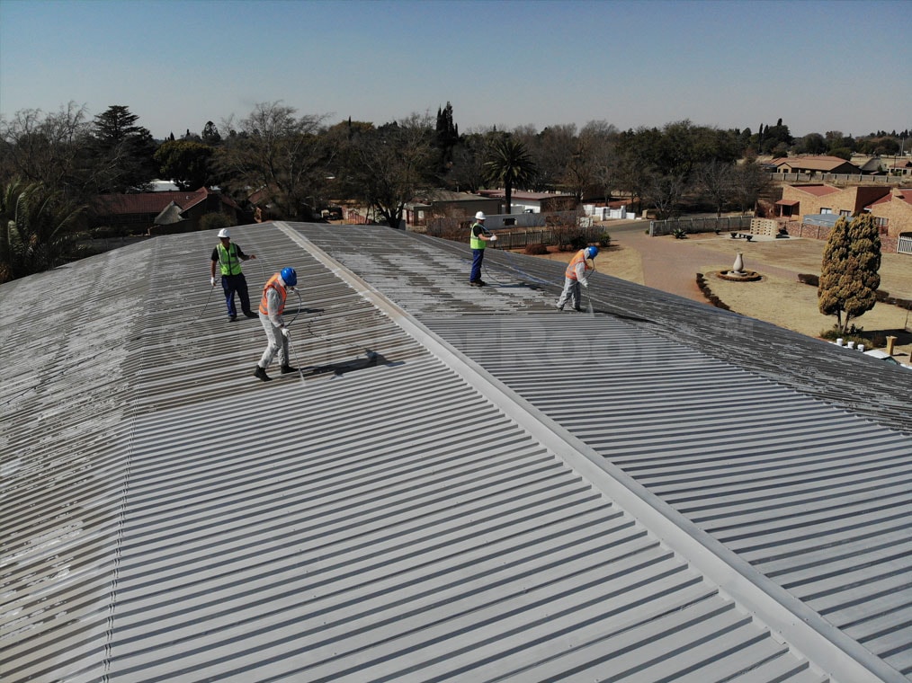Roof coating application by rubber roof specialists for durability and protection.