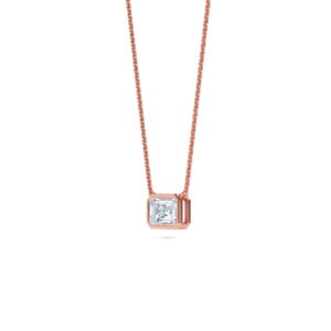 Elegant emerald bezel diamond pendant on rose gold chain.