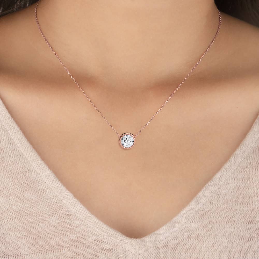Elegant round bezel solitaire diamond necklace for women. Perfect for special occasions and everyday.