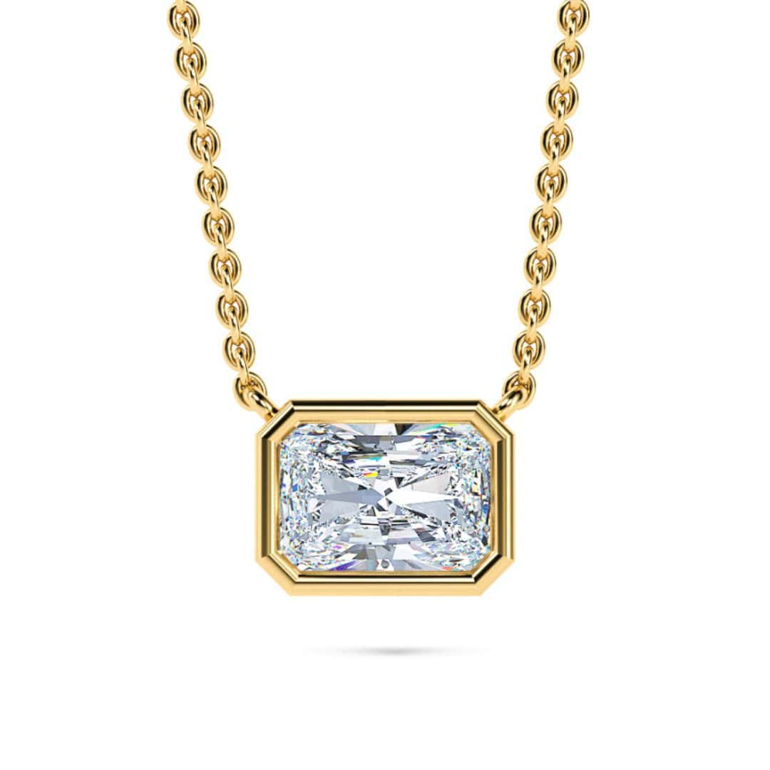 Elegant gold necklace with a large, radiant bezel-set diamond pendant. Perfect for sophisticated jew.