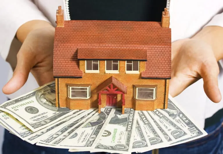 Carboard home on top of money