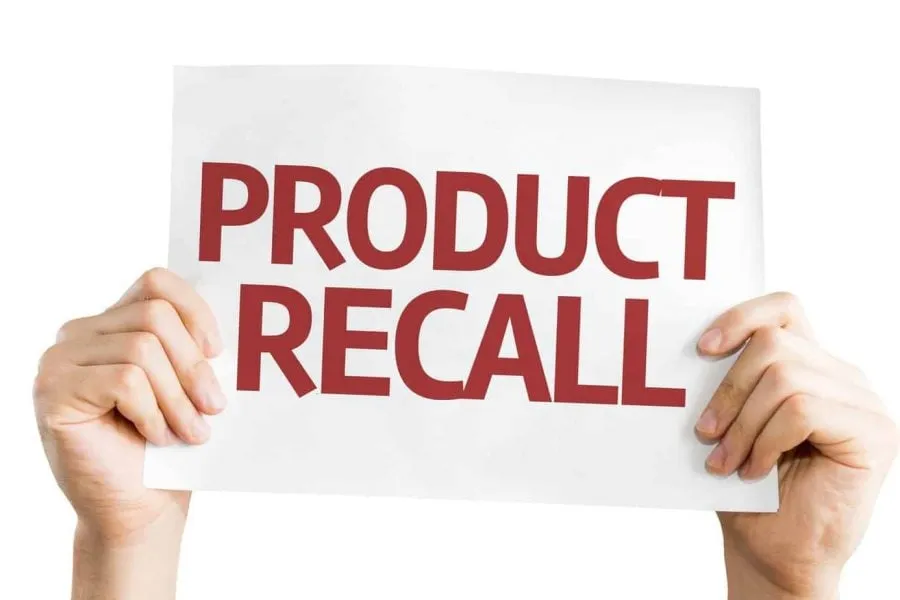 Hands holding product recall sign
