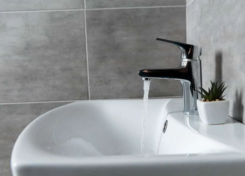 Sink faucet flowing with water