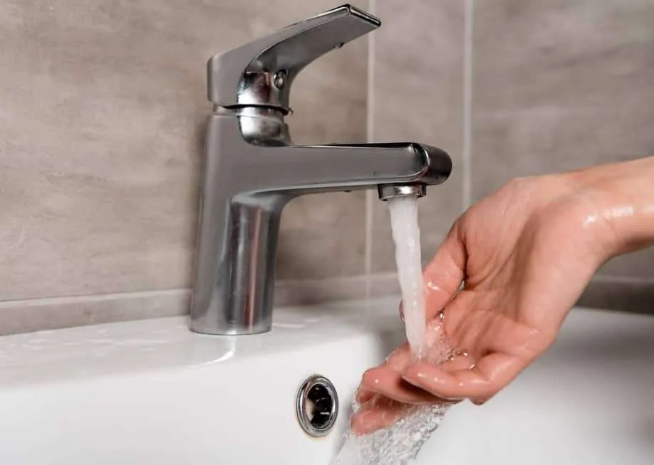 Faucet running water over a hand