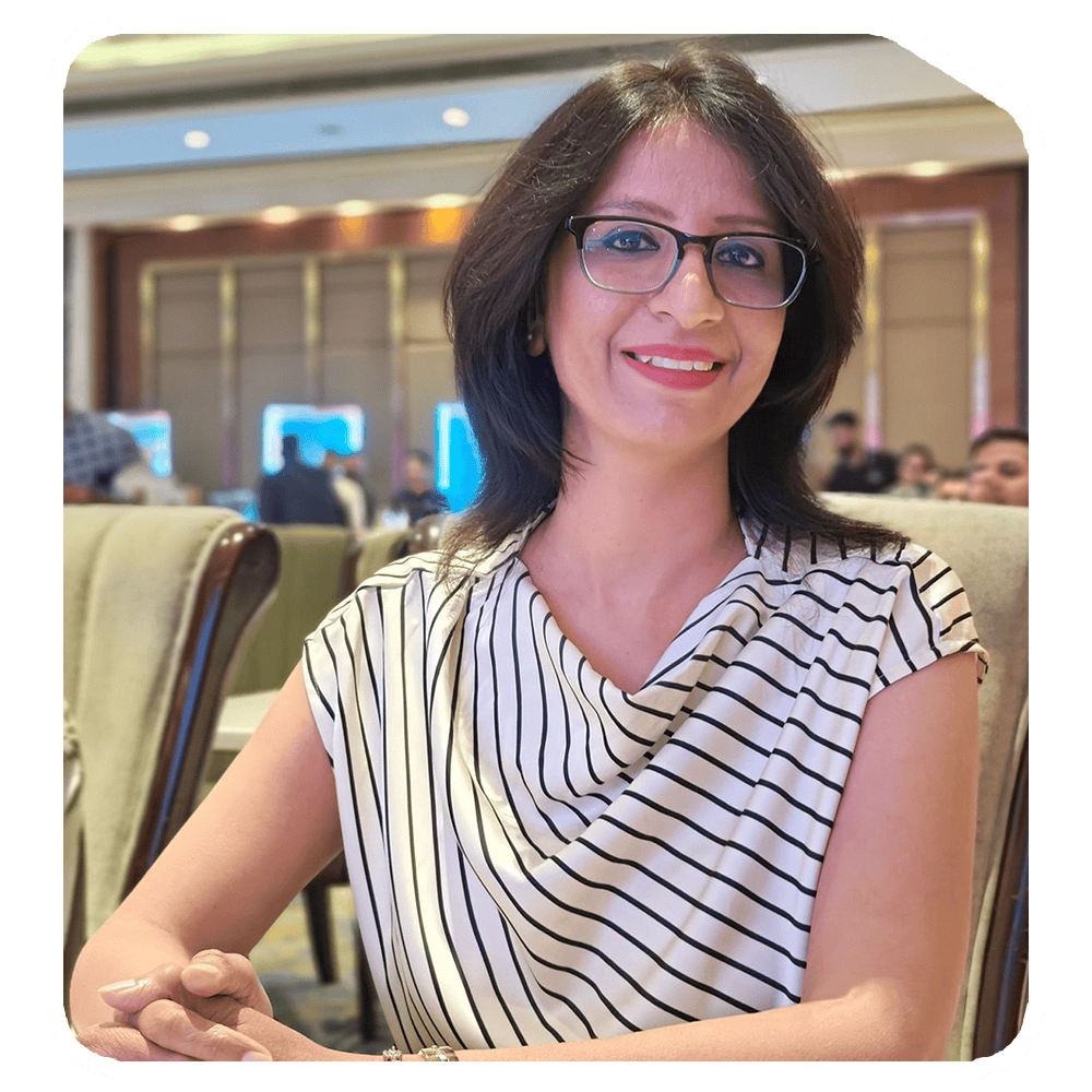 - Stylish woman wearing glasses at Sak Designs x Space Bound event, vibrant conference setting.