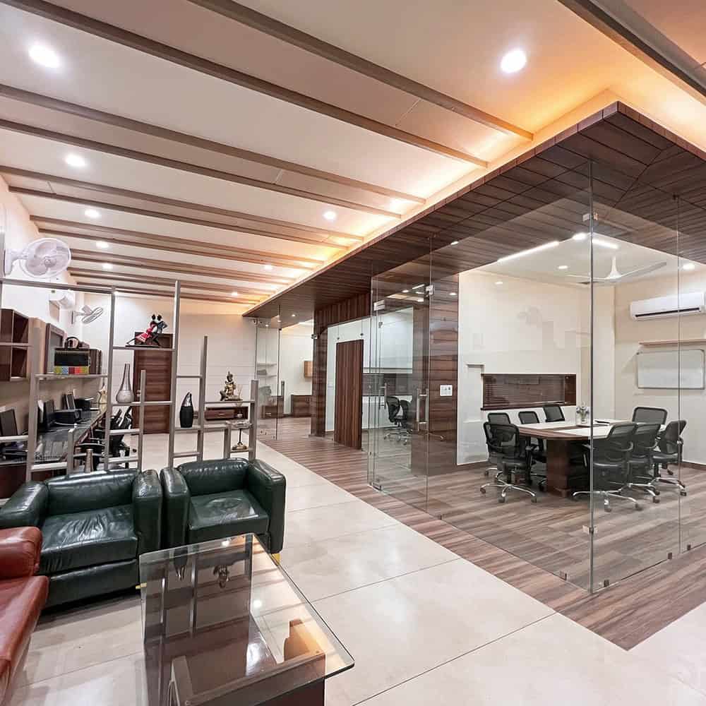 Contemporary office space with glass partitions, modern furniture, and stylish wooden accents, designed for productivity and comfort.
