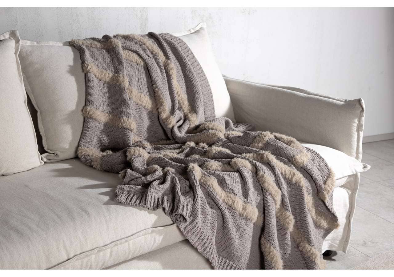 Mysig stickad pläd i grått och beige, perfekt för vardagsrum och sovrum.