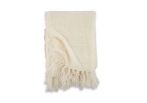 Linnefilt i ull med fransar, lyxig och mjuk, perfekt för sovrummet.