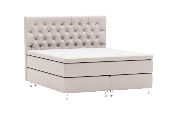 Elegant säng med stoppad huvudgavel i ljust tyg, perfekt för moderna sovrum.