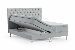 Säng med förvaring och lyft och vackert tuftad huvudgavel.