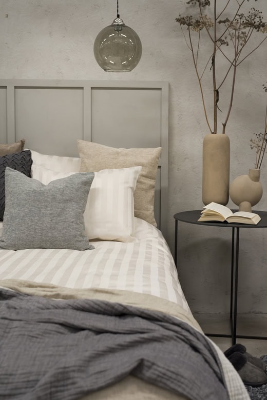 Madrass, kuddar och sängkläder i nordisk stil för en avkopplande sovrumsmiljö.