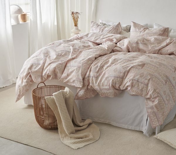 Mjuk, paisleymönstrad sängkläder i puderrosa för en elegant sovrumsmiljö.