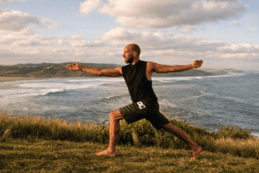 Bryan practicing yoga by the coast during a yoga retreat in Ticino