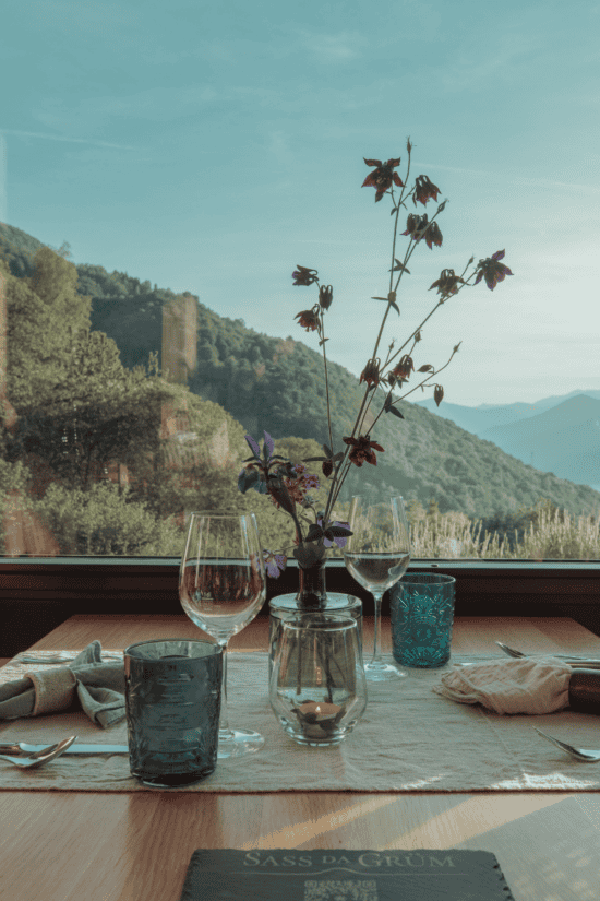 Guests dining at Sass da Grüm restaurant with panoramic views of Lake Maggiore in Ticino