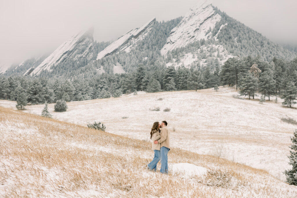 Stunning scenic view of couple kissing in front of the mountains at Chautauqua Park in Boulder Colorado