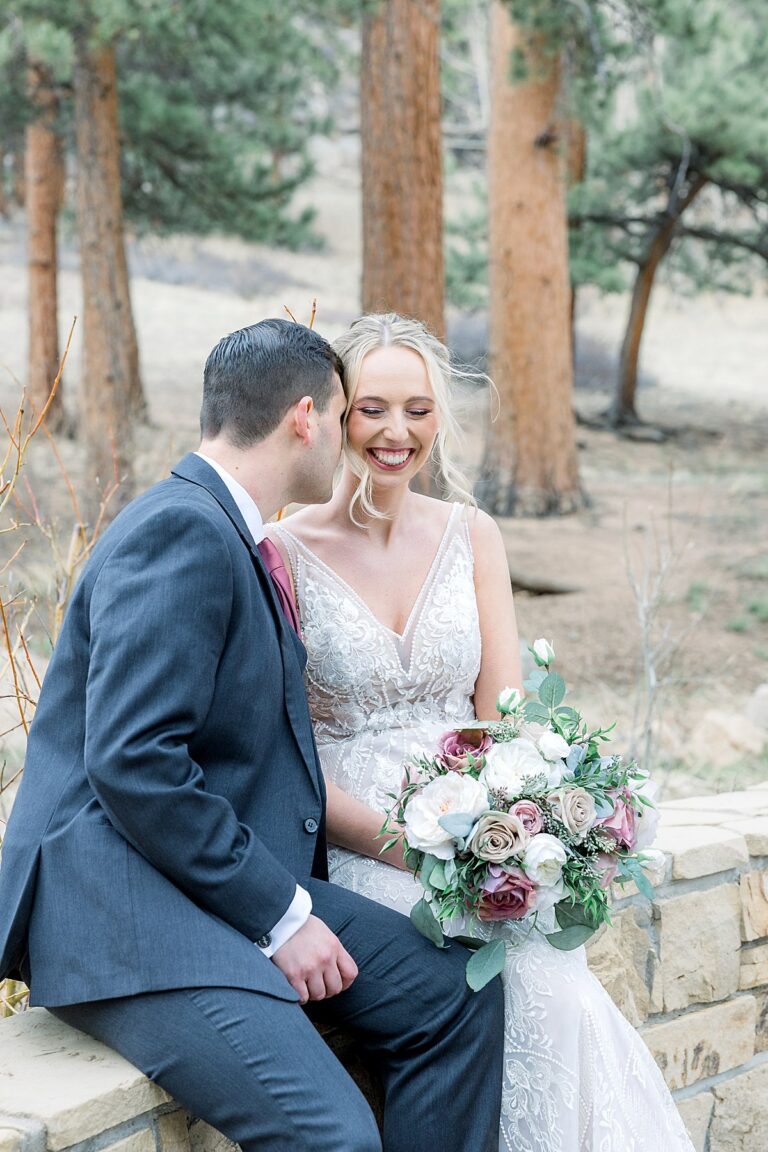 Groom whispering into brides ear making her laugh