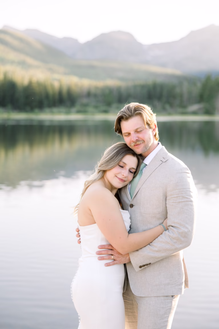 bride and groom cuddling into each other