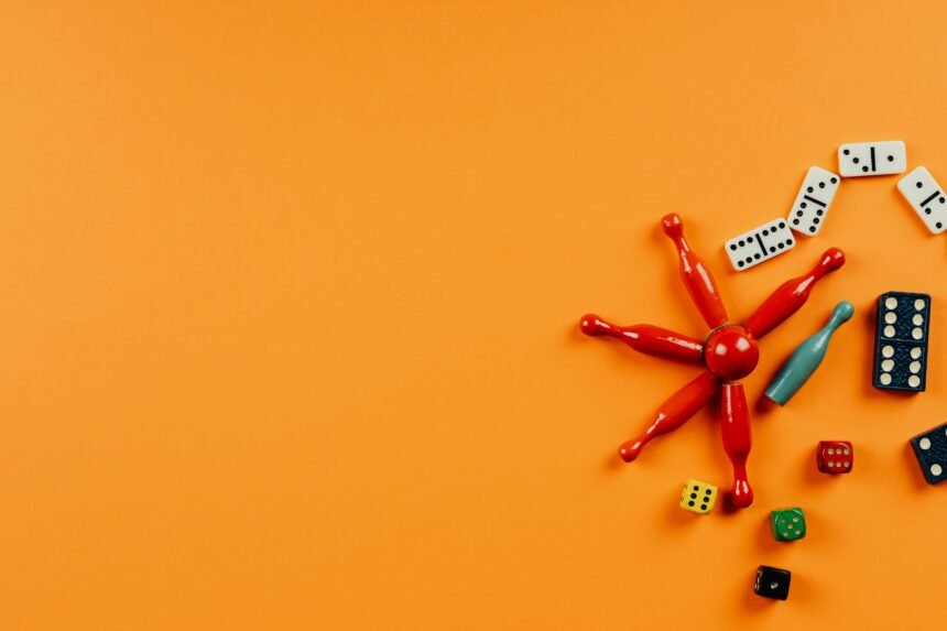 a group of game pieces and a red toy on an orange background