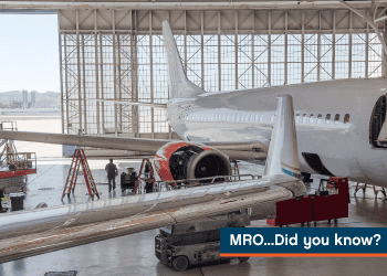A photo of a maintenance repair and overhaul hangar with aircraft, tools and a aircraft mechanic