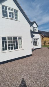 White painted house with modern windows, exterior decorating by S Bond Decorating in the UK.