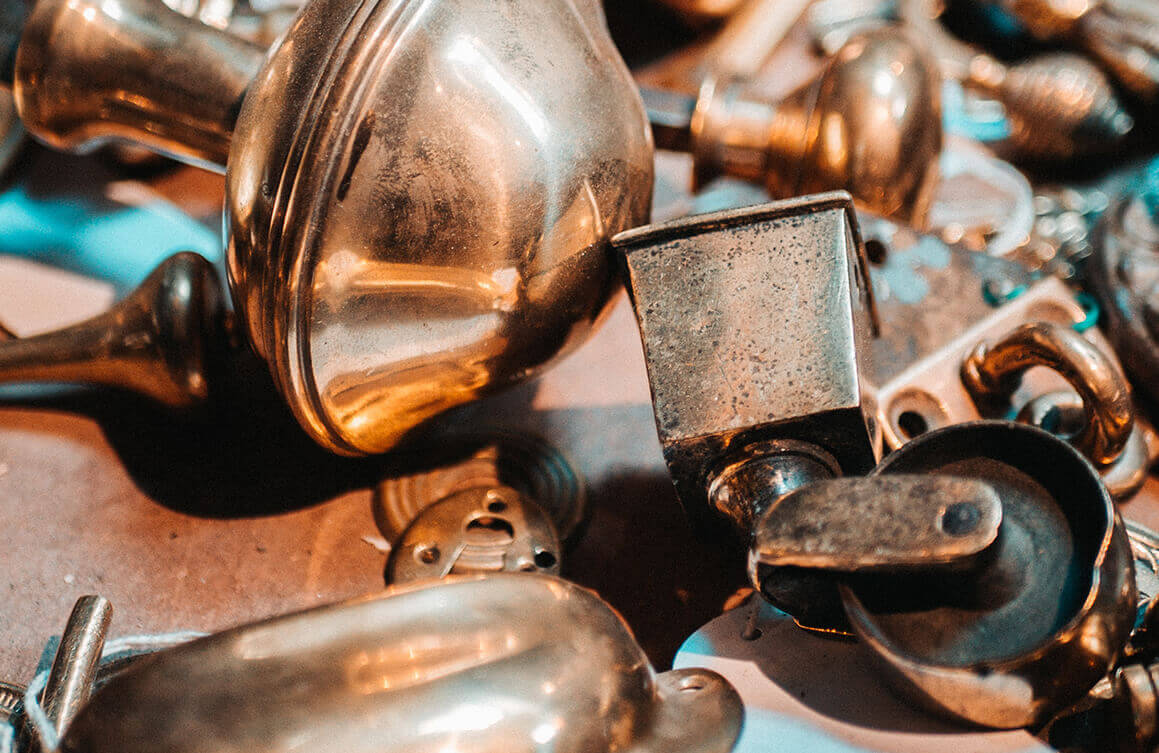 Assorted scrap metal pieces including kettles and hardware for recycling.