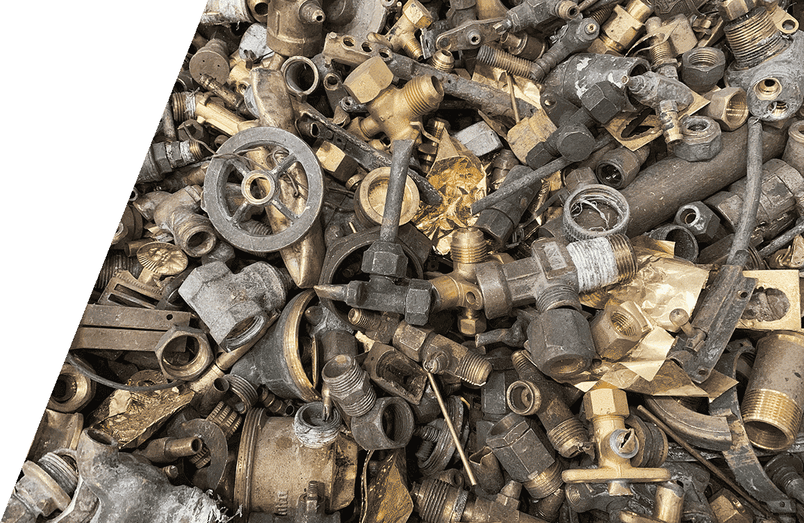 Assorted scrap metal pieces including valves, fittings, and bolts for recycling.