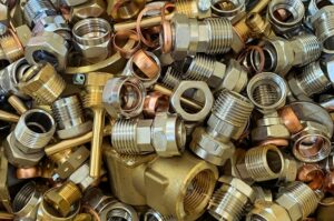 Mixed brass scrap metal including fittings and connectors.