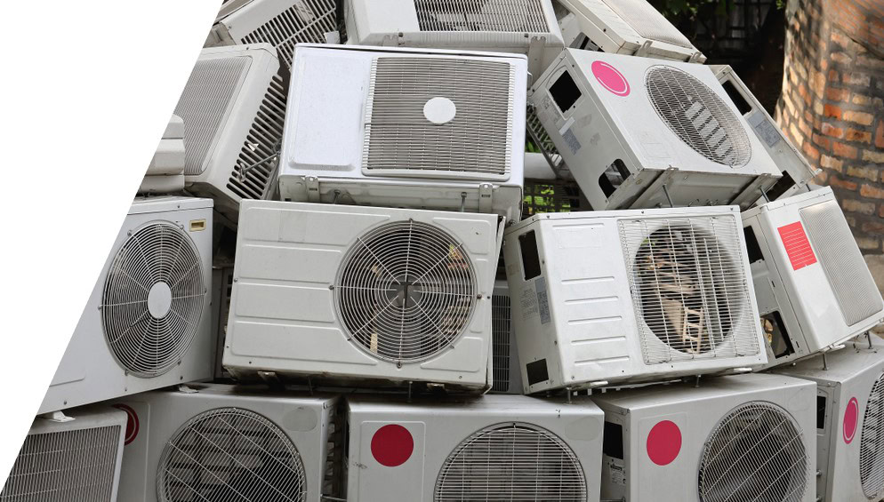 Pile of recycled air conditioning units for scrap metal collection.