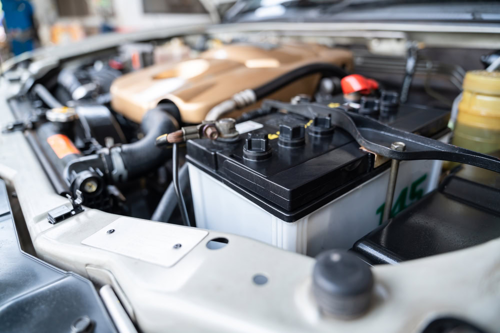 Car battery under the hood ready for recycling and scrap metal processing.