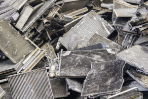 Pile of scrap radiators and metal parts for recycling.