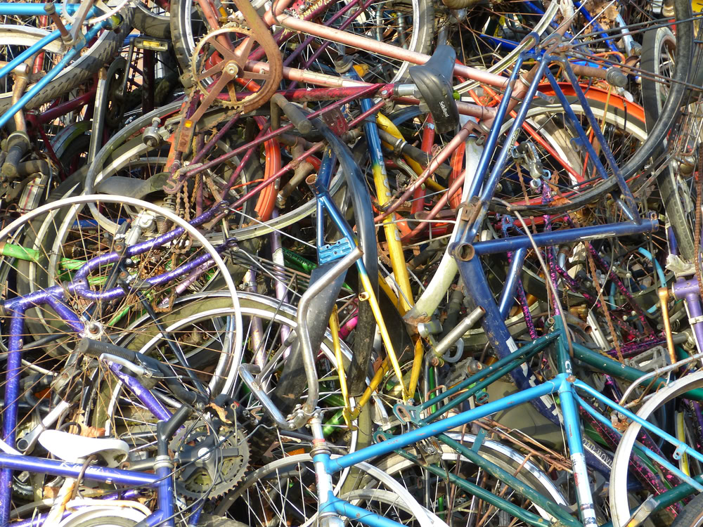 Pile of assorted scrap metal bikes and bicycle parts for recycling.