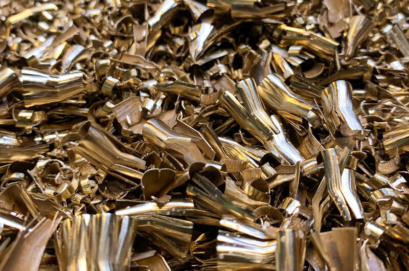 Close-up of shiny brass turnings for scrap metal recycling.