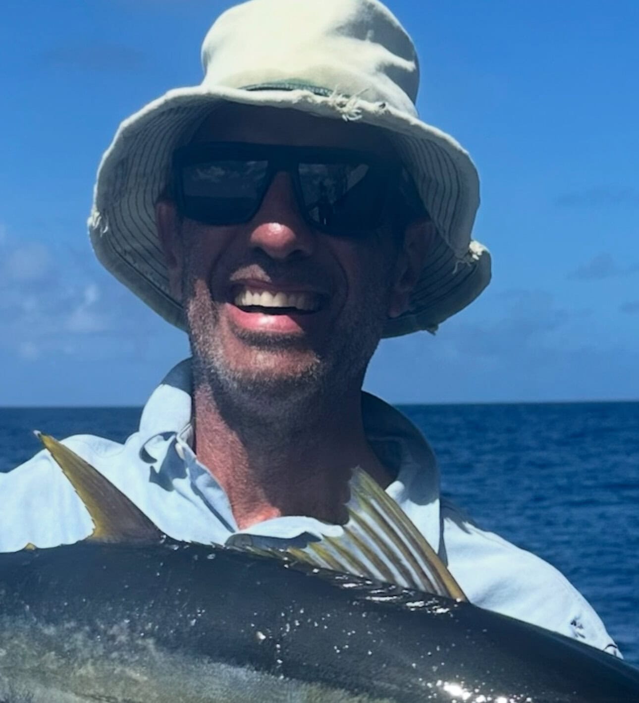 Fisherman holding a tuna in the Amirantes Seychelles moments before release