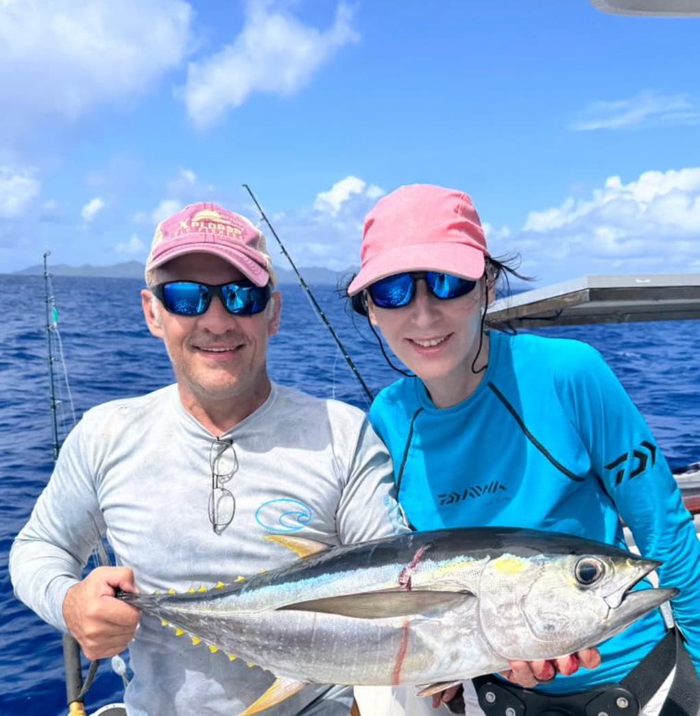 Anglers holding a yellowfin tuna in the Seychelles prior to release