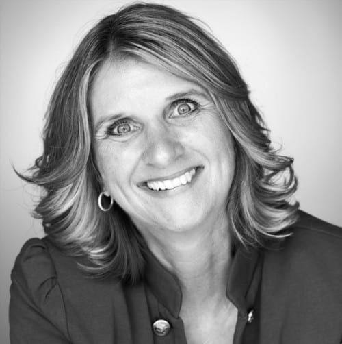 Freundliche Frau mit lockigem Haar, Lächeln, professionellem Aussehen, Porträt.