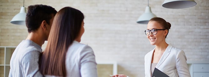 Modern real estate agent consulting happy clients in West Michigan, offering exceptional property buying and selling services.