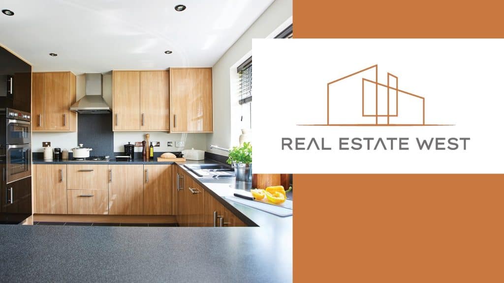 Modern kitchen with wooden cabinetry and black countertops in West MI home.
