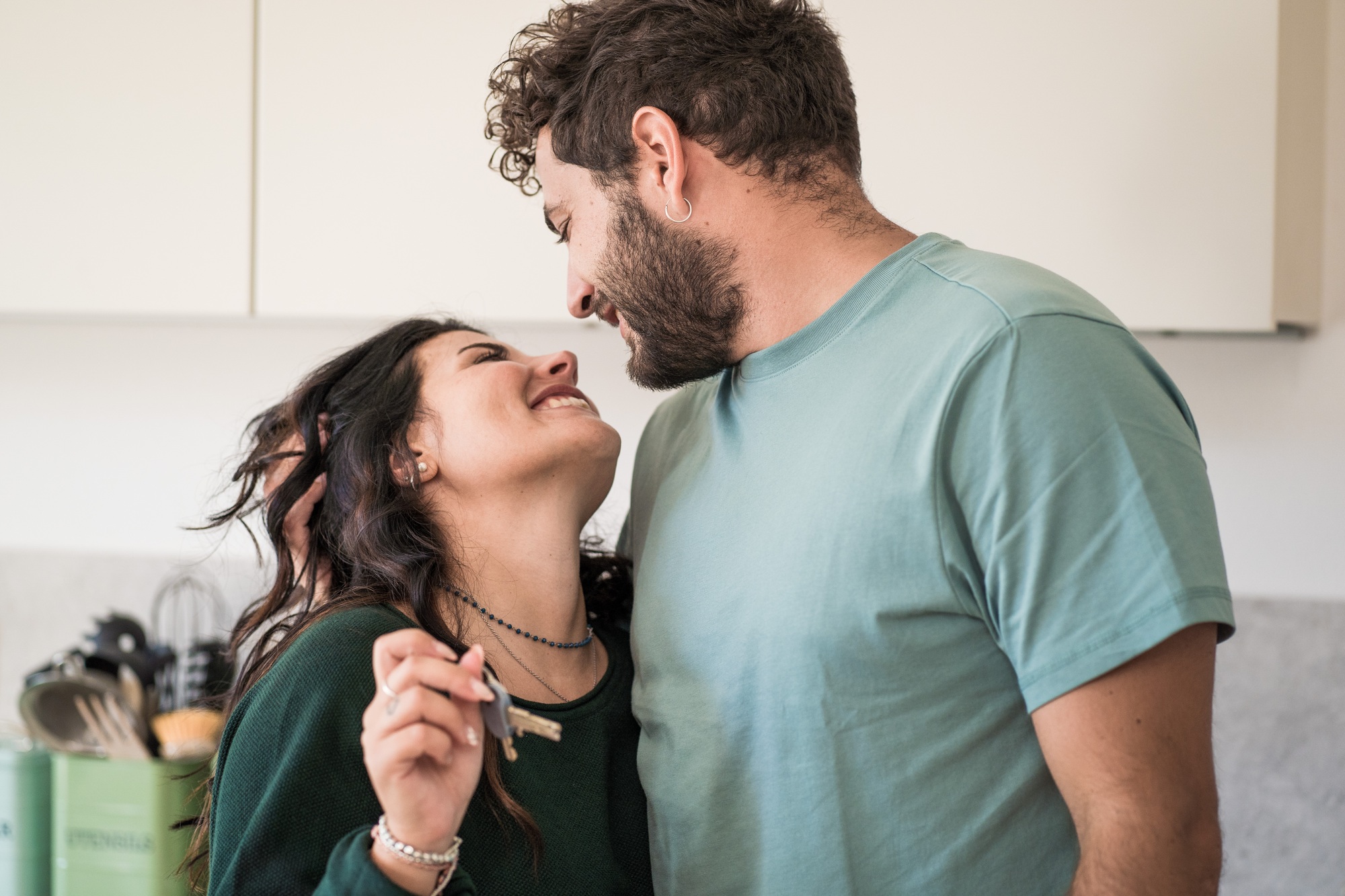 A young married couple rejoices over the purchase of the new house