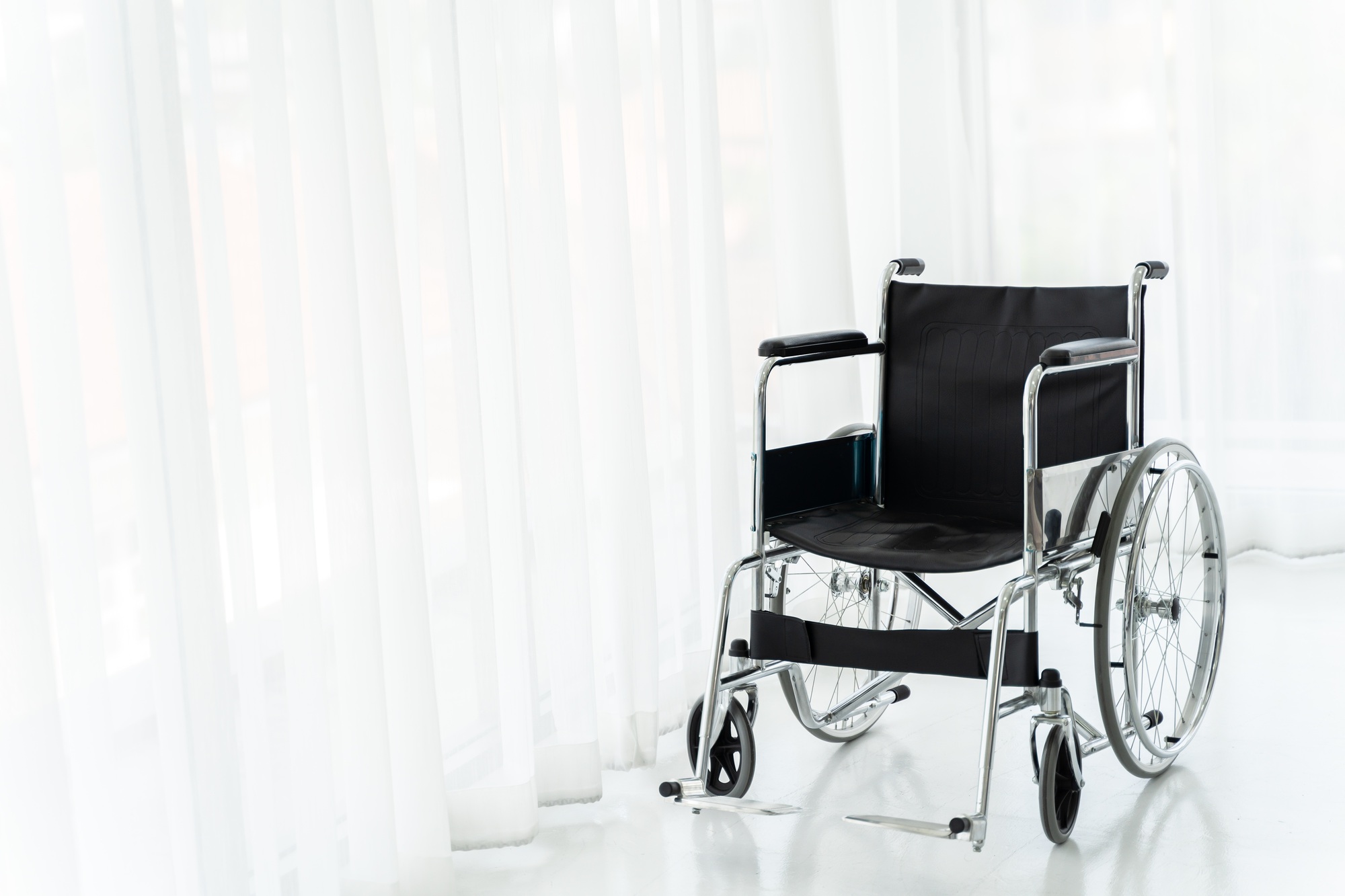 Empty wheelchair in hospital ward