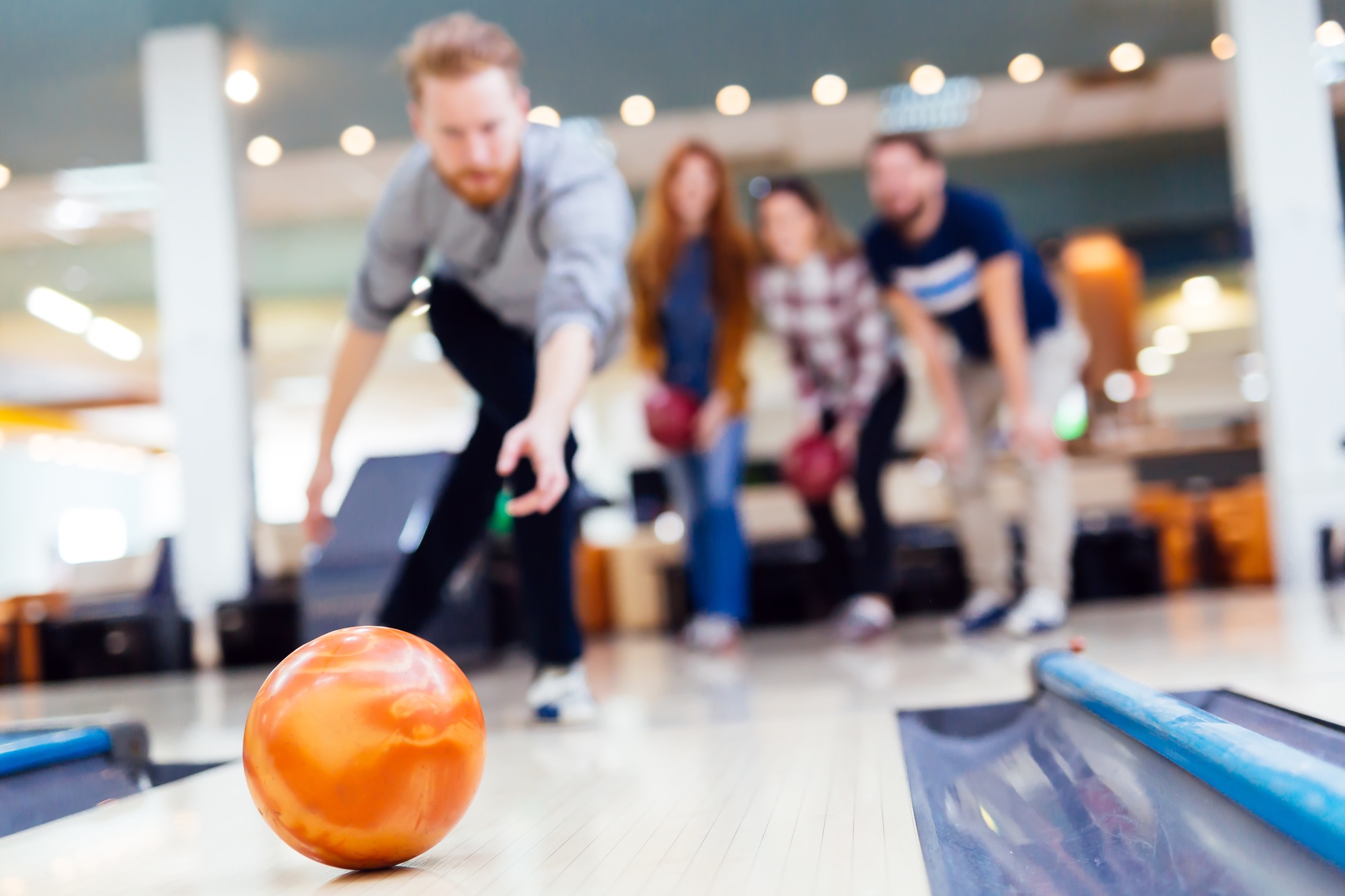 Friends enjoying bowling at club