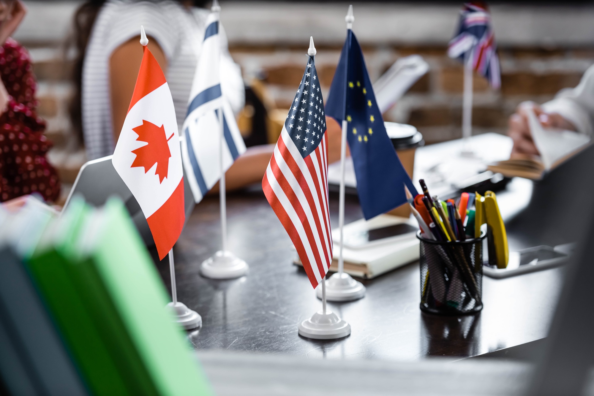 selective focus of flags of america, canada, european union and israel