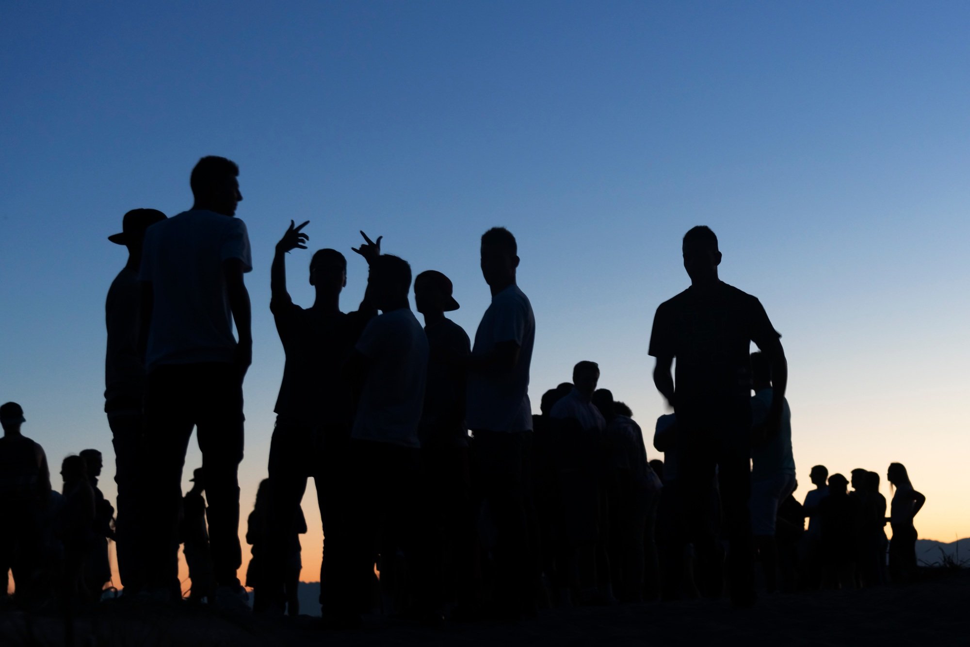 Gen Z silhouetted outdoor party