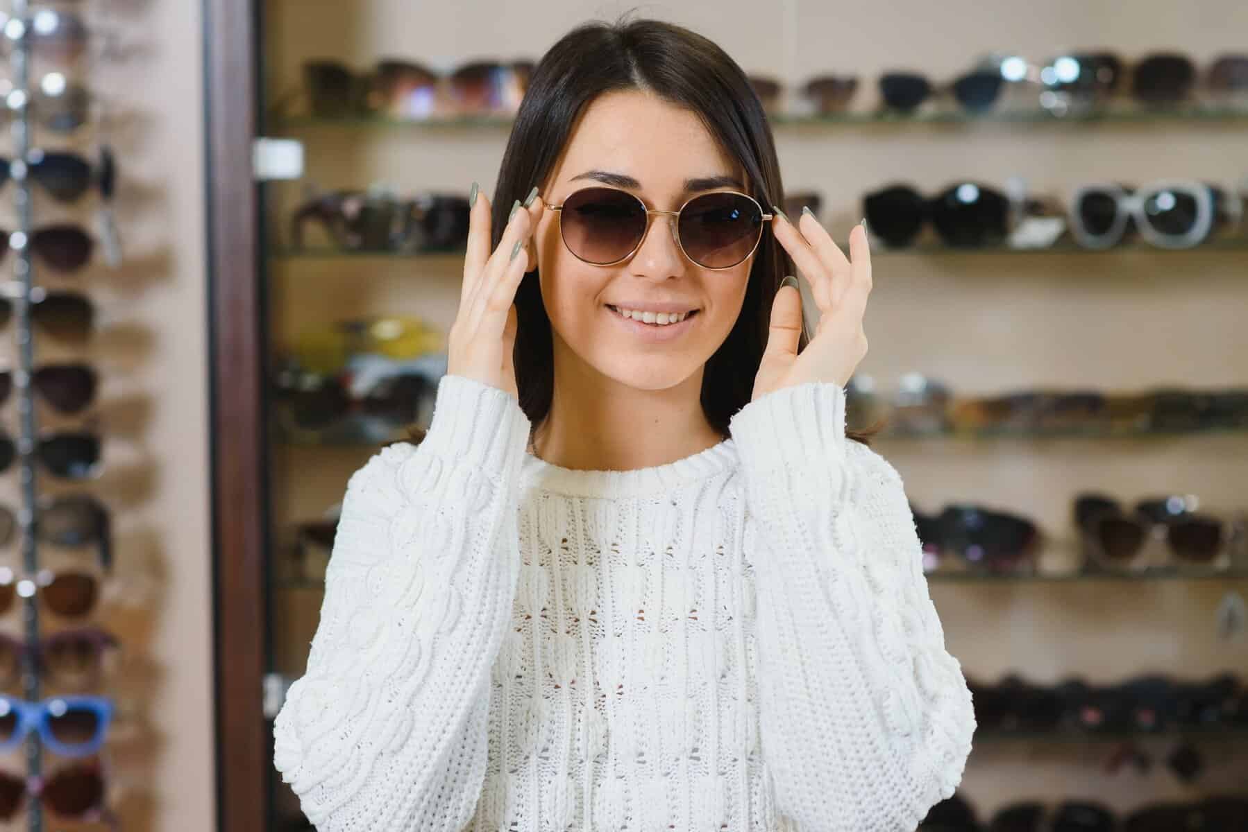 Which one is better fit me. Portrait of cheerful hesitating woman in optician store