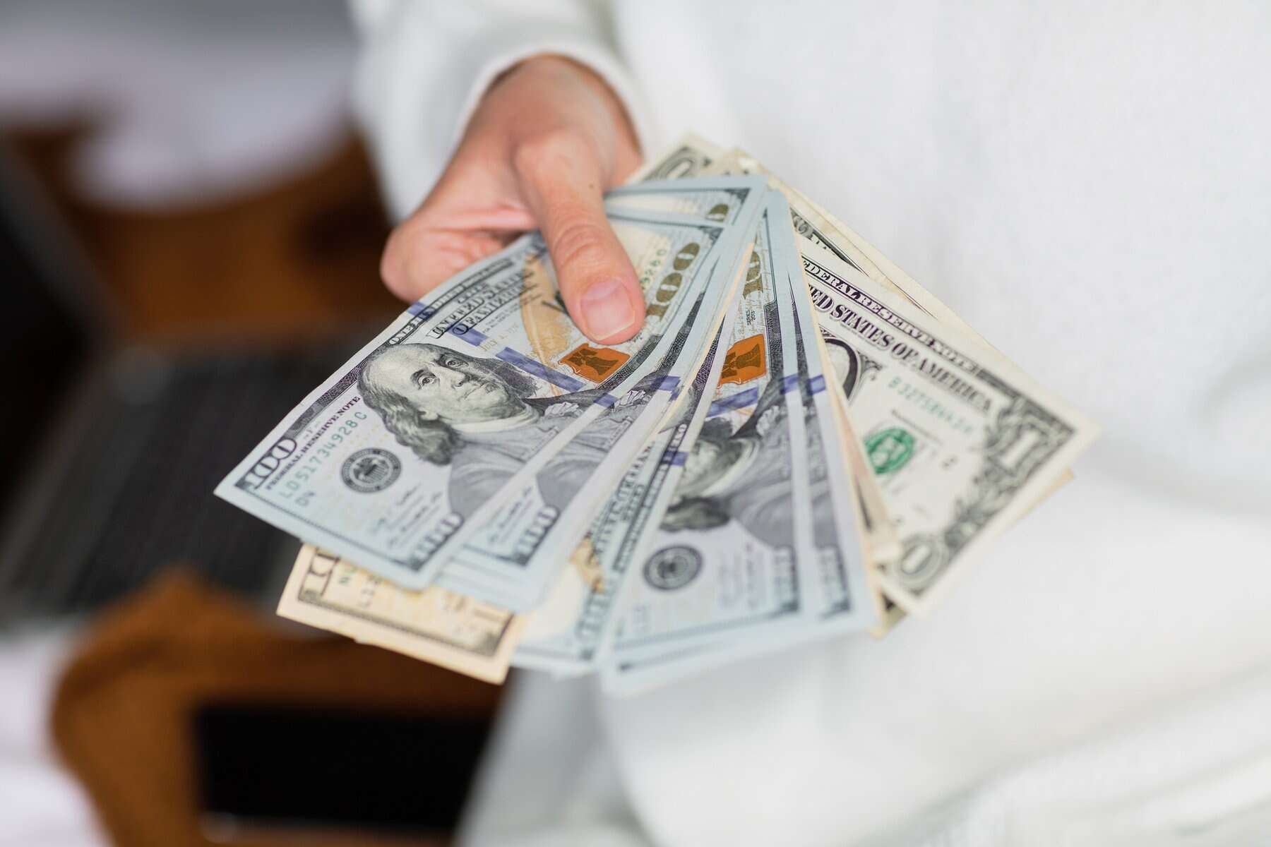 Woman holding hands cash money one hundred dollars bills