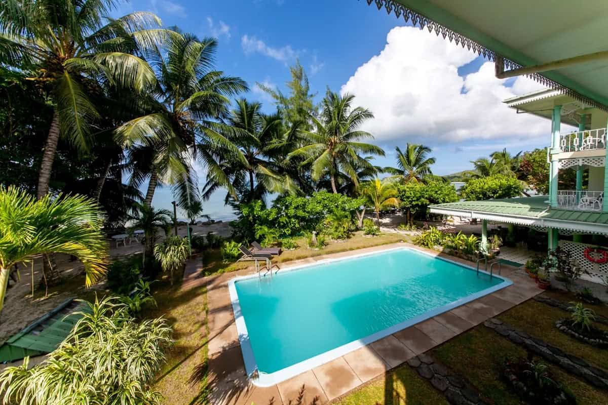 Palm Beach Hotel — beachfront pool and sunset, Praslin